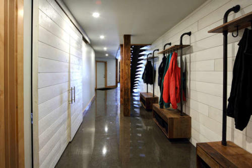 New construction Banff Canmore open concept polished concrete floors wood contemporary industrial wood stairs metal railings wood barn doors 