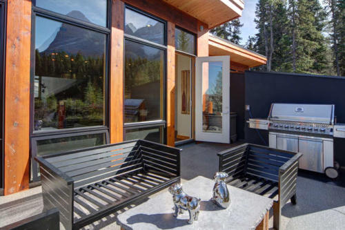 New construction Banff Canmore  open concept hardwood floors wood contemporary industrial wood stairs metal railings wood barn doors mountain view decks