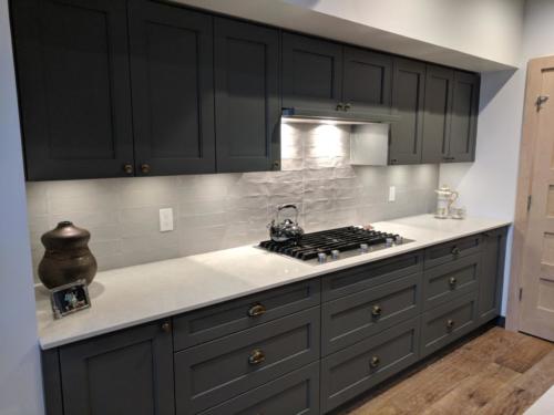New construction Banff Canmore kitchen grey stainless steel appliances white brick backsplash  open concept hardwood floors wood panel ceiling timberframe wood contemporary industrial design steel baseboards