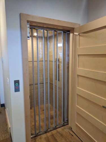 New construction Banff Canmore elevator open concept hardwood floors wood panel ceiling timberframe wood contemporary industrial design wood doors steel baseboards