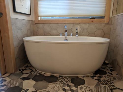 New construction Banff Canmore bathroom open concept patterned mosaic tiles timberframe wood contemporary industrial design wood doors steel baseboards