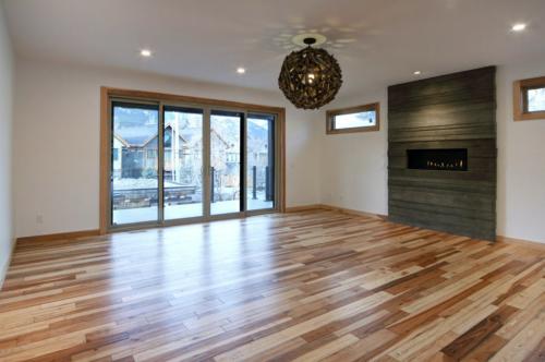 New construction Canmore hickory wood floors wood light fixture concrete fireplace contemporary industrial design 