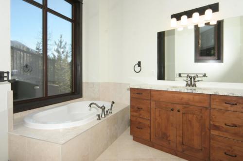 New construction Banff Canmore bathroom ensuite open concept hardwood floors timberframe wood contemporary industrial stone counter tops wood vanity 
