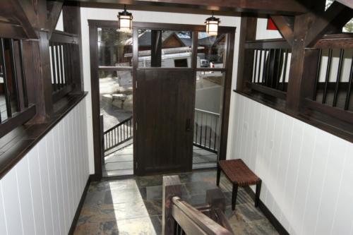 New construction Banff Canmore front entrance wood door open concept slate floors timberframe wood contemporary industrial 