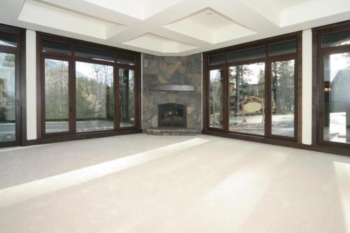 New construction Banff Canmore living entertaining room open concept hardwood floors timberframe wood contemporary industrial wainscoting walls stone fireplace