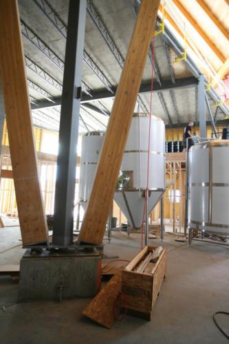 New construction Banff Canmore timberframe commercial brewery open concept wood concrete floors contemporary industrial wood stairs metal railings steel beams