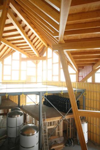 New construction Banff Canmore timberframe commercial brewery open concept wood concrete floors contemporary industrial wood stairs metal railings steel beams