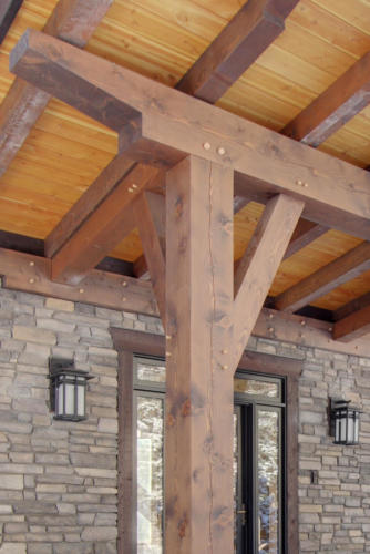 New construction Banff Canmore timberframe stone front entrance open concept hardwood floors wood contemporary industrial wood stairs metal railings wood barn doors 