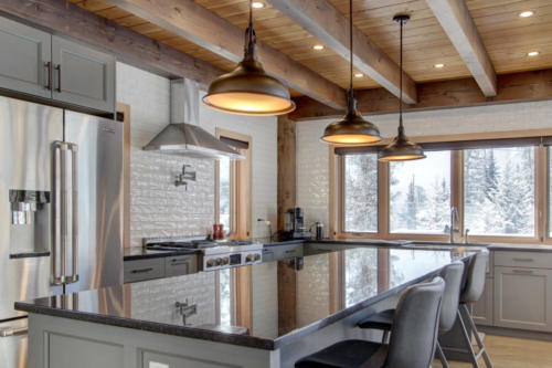New construction Banff Canmore grey kitchen white brick backsplash stainless steel appliances timberframe open concept hardwood floors wood contemporary industrial wood stairs stone counter tops