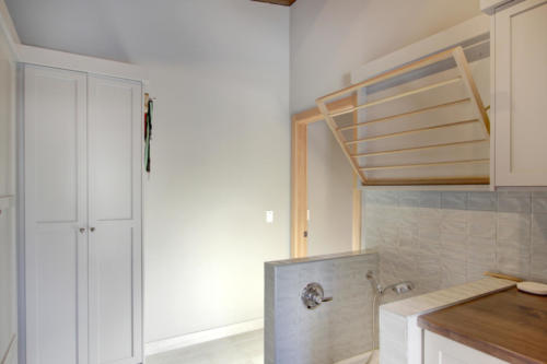 New construction Banff Canmore laundry room dog wash steel fireplace timberframe open concept hardwood floors wood contemporary industrial wood stairs metal railings wood barn doors 